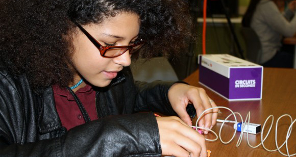 Sixth-grader Selena Williamson learns circuitry basics hands-on.