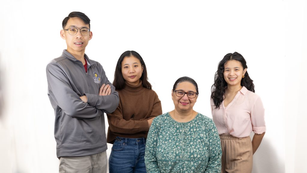 Team members standing together and smiling.